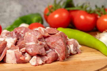 Diced cow meat. Fresh beef on a wooden floor. Close up