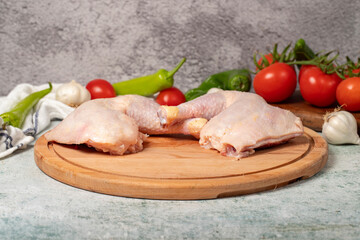 Chicken wings. Peeled raw chicken wings on a wood serving board