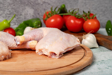Chicken wings. Peeled raw chicken wings on a wood serving board. Close up