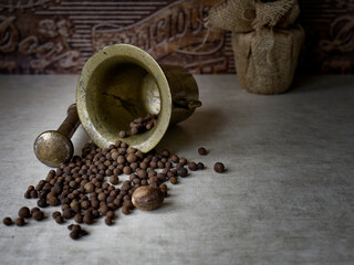 Pepper, spice and mortar on table.