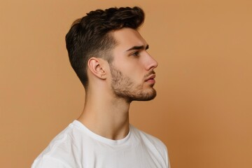 Obraz premium Young man in white t shirt with stubble profile photo