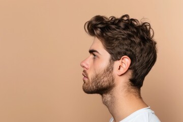 Obraz premium Young handsome man with bristle in profile photo pose