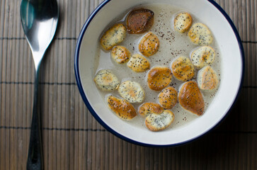 Poppy seed vegan milk with baked  - traditional Lithuanian drink in a traditional 12 dish Christmas Eve dinner - baked dough pieces traditionally served during Lithuanian Christmas Eve