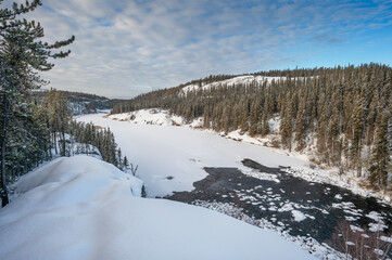 Winter overview of the frozen Cameron River in Hidden Lake Territorial Park, Northwest Territories, Canada