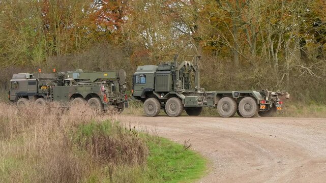 British army MAN SVR 8x8 (Support Vehicle Recovery) truck towing a MAN HX77 8x8 EPLS heavy utility vehicle, Wiltshire UK