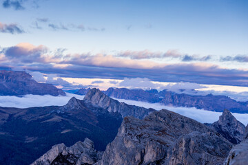 Mountains above the clouds stunning landscape. High rocky peaks rising through mist, this scene captures dramatic high-altitude views with soft cloud cover and rugged terrain in Dolomiti Alps