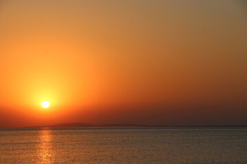 Sunrise over the sea. Sunset above ocean. Sun rising over the surface of sea