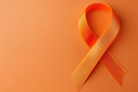 World Multiple Sclerosis Day. Horizontal banner. Copy space. Orange ribbon on a orange background for leukemia, kidney cancer, multiple sclerosis RSD awareness