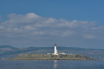 Pladda Lighhouse from the sea on a calm day, Arran, Scotland, UK