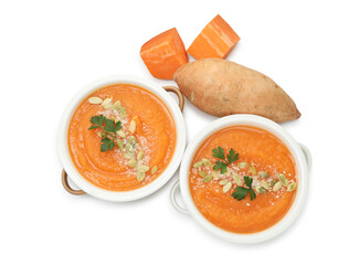 Delicious sweet potato soup with pumpkin seeds in bowls and fresh vegetable isolated on white, top view