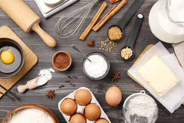 Baking powder and other products on grey wooden table, flat lay