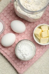 Baking powder and other ingredients for making dough on table, top view