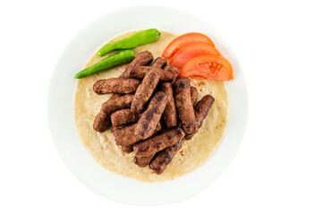 Turkish style meatballs on lavash, served with tomatoes and fresh peppers.