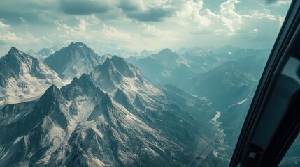 Breathtaking aerial view of rugged majestic mountain peaks and picturesque alpine landscape captured from the cockpit of a helicopter soaring high above the serene wilderness This awe inspiring