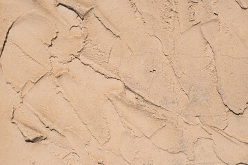 Textured sand surface with natural patterns visible