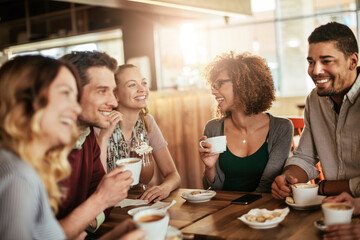Group of young people enjoying a coffee in a cafe