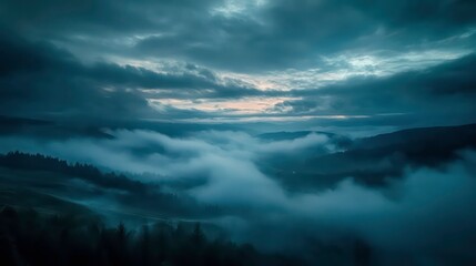 Obraz premium A mesmerizing view of a valley blanketed in fog at dawn, with the sun's light breaking through the clouds.