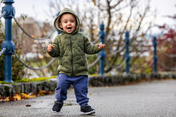Joyful Toddler Walking in Park on a Cloudy Day