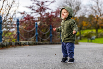 Smiling Toddler Enjoying Outdoor Stroll in Cozy Autumn Clothing