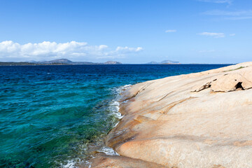 Sardinia. Amazing crystal clear emerald blue turquoise water of the Mediterranean sea touches huge...