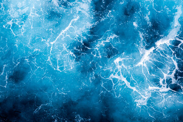 Ocean water surface texture. Aerial view of captivating water with foam. Can be used in covers, packaging, posters, textures, presentations, art and design projects. Beautiful nature background image.