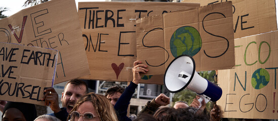 Close-up of global warming banners, activist people protesting for the earth and warning about...