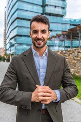 Young businessman wearing suit standing smiling in the city