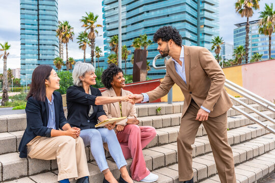 Businessman shaking hands with businesswoman in an outdoor meeting