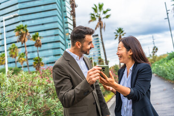 Surprised business people using mobile standing in the city