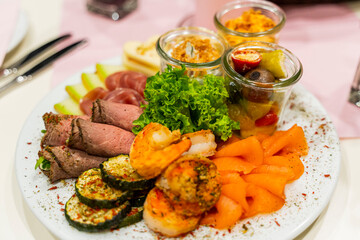 A plate with different appetizers at a wedding buffet