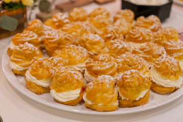Small German cream puffs (Windbeutel) at a wedding buffet
