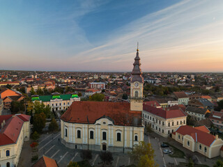 Obraz premium European bell tower with old red roof town in the background, Vršac, Serbia - aerial drone photo