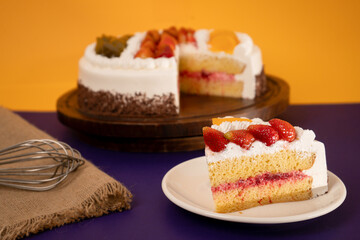 Delicious Slice of Cake Topped strawberries, fruits and Cream Set Against a Bright Yellow Background