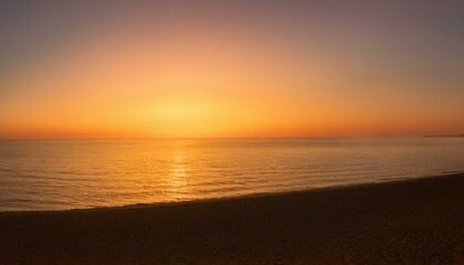 Fototapeta premium Golden hour sunset over a tranquil ocean. Warm colors paint the sky and water, creating a serene and peaceful atmosphere.