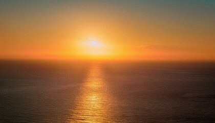 Fototapeta premium Golden hour sunset over the ocean. Warm hues paint the sky and water, creating a serene and peaceful atmosphere.