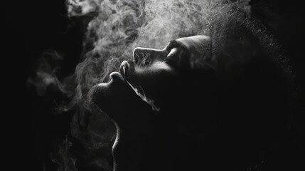 Silhouette of a person exhaling smoke against a dark background.