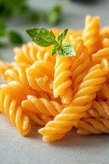 A close-up of delicious, spiral pasta garnished with a fresh basil leaf, perfect for culinary blogs, recipe books, or advertising Italian cuisine, This vibrant image enhances food-related content,