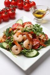 Delicious shrimp salad with vegetables on white table, closeup