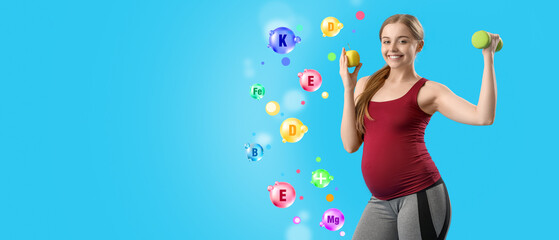 Fototapeta premium Sporty pregnant woman with apple and dumbbell on blue background