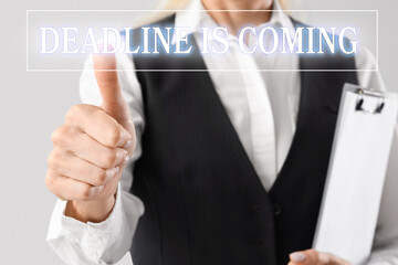Mature businesswoman with clipboard using virtual screen on light background, closeup