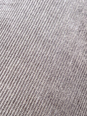A detailed macro shot of gray corduroy fabric, showcasing its ridged pattern and textured surface. Perfect for design, fashion, or textile-focused projects.