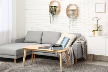Interior of living room with sofa and record player on table