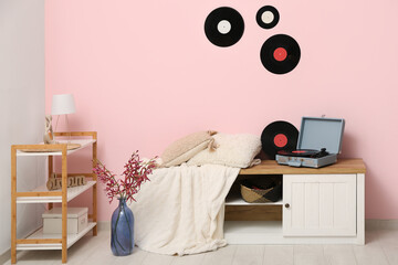 Interior of living room with record player and disks on commode