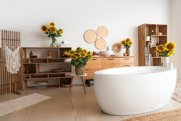 Bouquets of sunflowers in interior of bathroom