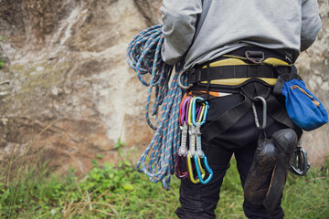 Fototapeta premium Close-up of a thigh climber with all equipment hanging on safety harness, prepared for rock climbing