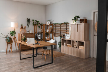 Interior of podcaster's studio with workplace, drawers and plants