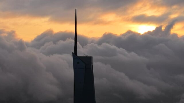 dramatic sunrise with low cloud above Kuala Lumpur city center visible sky scraper tower above the cloud
