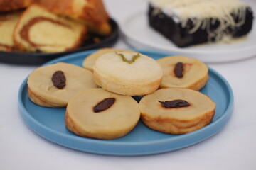 Kue Lumpur or Mud Cake, Indonesian traditional cake made from potato, flour, eggs and coconut milk topped with raisins served on white plate. beautiful decoration