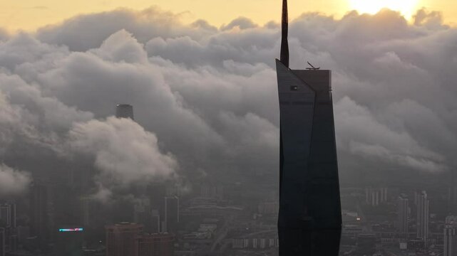 dramatic sunrise with low cloud above Kuala Lumpur city center visible sky scraper tower above the cloud