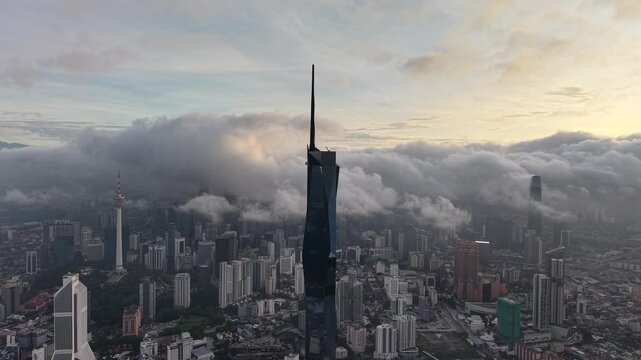 dramatic sunrise with low cloud above Kuala Lumpur city center visible sky scraper tower above the cloud